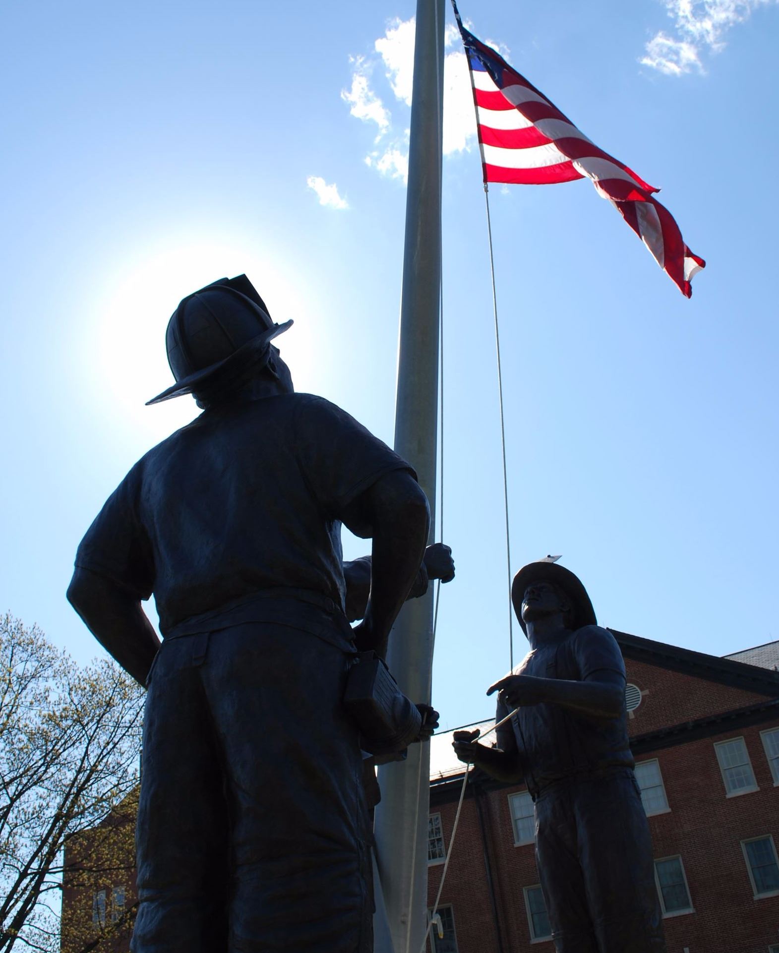 Statues of Firemen raising a flag, blue sky sunny day